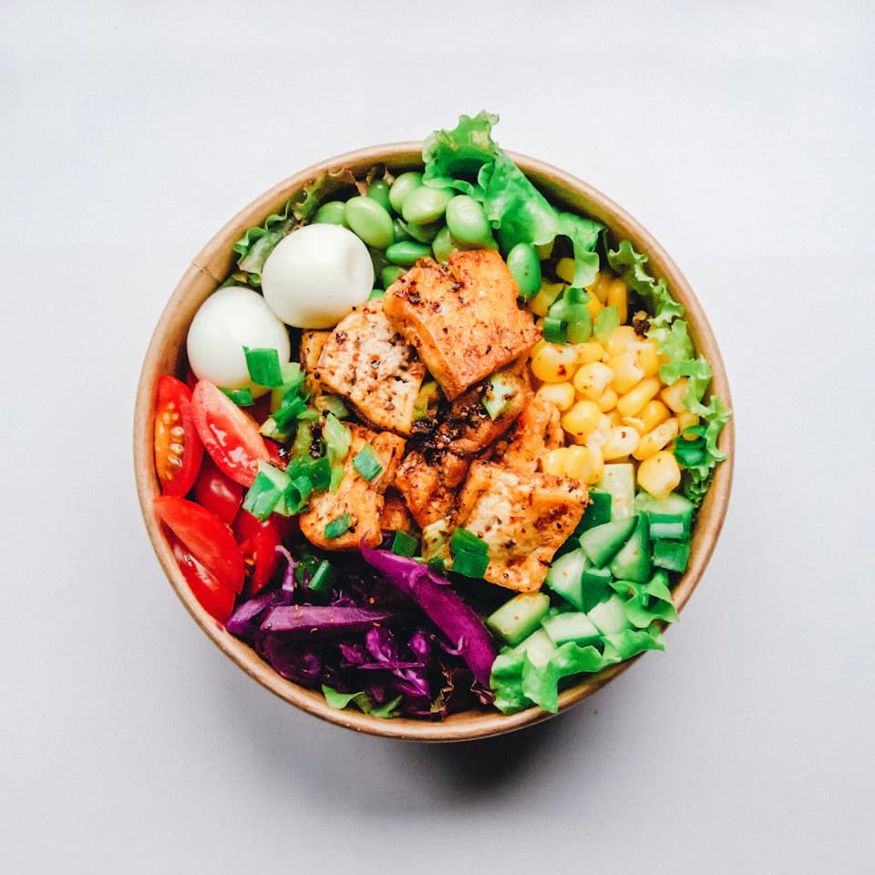A colorful bowl of vegetables and grains, ready for dinner